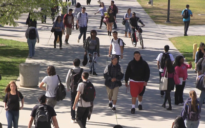 Small college students walking to class e1roiowu f0000