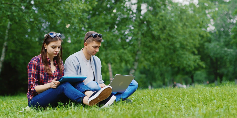 Medium college students studying together in nature enjoy your tablet and laptop haaqay q  f0000